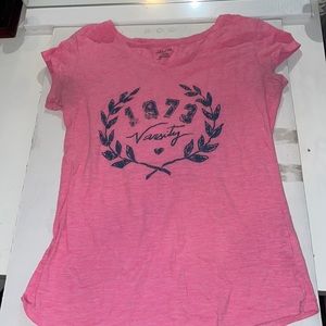 Pink “Varsity 1973” shirt.